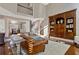 Open-concept living room featuring hardwood floors, built-in shelving and easy access to the dining room at 4095 Oberon Se Ct, Smyrna, GA 30080