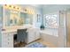 Bright main bathroom with a large vanity, standing shower, and a large bathtub at 4095 Oberon Se Ct, Smyrna, GA 30080