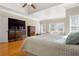 Bright main bedroom with hardwood floors, tray ceiling, sitting area and a large dresser at 4095 Oberon Se Ct, Smyrna, GA 30080