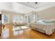 Bright main bedroom featuring hardwood floors, tray ceiling, sitting area and many windows at 4095 Oberon Se Ct, Smyrna, GA 30080
