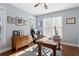 Well-lit office with hardwood flooring features a large desk, dresser, and natural light at 4095 Oberon Se Ct, Smyrna, GA 30080