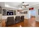 Recreation room with hardwood floors, ceiling fan, built-in shelving and a tv at 4095 Oberon Se Ct, Smyrna, GA 30080