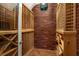Elegant wine cellar with brick walls and custom wooden storage racks at 4095 Oberon Se Ct, Smyrna, GA 30080
