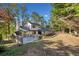 Large backyard showcasing a deck and the home's exterior nestled in a wooded lot at 4861 Karls Gate Dr, Marietta, GA 30068