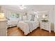 Bedroom with two beds, light hardwood floors, and a mirror at 4861 Karls Gate Dr, Marietta, GA 30068