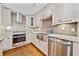 Kitchen boasts custom cabinets, granite countertops, and stainless steel appliances at 4861 Karls Gate Dr, Marietta, GA 30068