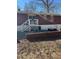 Backyard of a brick home with a patio and stair access to the upper level at 6756 Brookwood Cir, Jonesboro, GA 30043