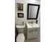 Bathroom featuring a classic vanity with white cabinet and framed decor at 6756 Brookwood Cir, Jonesboro, GA 30043