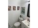 Small bathroom with a wall decor, toilet and sink at 6756 Brookwood Cir, Jonesboro, GA 30043