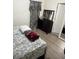 Bedroom featuring a dark wood dresser, mirror, and patterned linens at 6756 Brookwood Cir, Jonesboro, GA 30043
