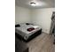 Bedroom features neutral walls, patterned linens, and hardwood floors at 6756 Brookwood Cir, Jonesboro, GA 30043