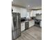 Eat-in kitchen boasts stainless steel appliances, white cabinets, and granite countertops at 6756 Brookwood Cir, Jonesboro, GA 30043