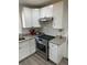 Updated kitchen featuring white cabinets, granite countertops, and stainless steel appliances at 6756 Brookwood Cir, Jonesboro, GA 30043