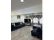 Spacious living room with modern gray floors, a ceiling fan, and large windows at 6756 Brookwood Cir, Jonesboro, GA 30043