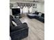Open concept living room featuring a large, comfortable sofa and modern floors at 6756 Brookwood Cir, Jonesboro, GA 30043
