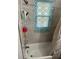 Shower featuring grey tiling, caddy with essentials, and a patterned shower curtain at 6756 Brookwood Cir, Jonesboro, GA 30043