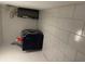 The basement area has utility appliances with white tiled walls and floors at 6756 Brookwood Cir, Jonesboro, GA 30043