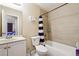 Cozy bathroom featuring a tile shower with curtain and a modern vanity with stainless steel faucet at 4196 Rocky Face Dr, Douglasville, GA 30135