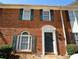 Charming brick townhouse with dark green shutters and a well-maintained front entrance at 5647 Executive Way, Norcross, GA 30071