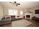 Bright living room with a fireplace, large windows, and modern furnishings at 5647 Executive Way, Norcross, GA 30071