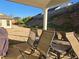 Covered patio with outdoor seating overlooking the fenced backyard and landscaped hillside at 1200 Bar Harbor Pl, Lawrenceville, GA 30044