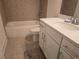 This bathroom features a shower-tub, toilet, and vanity with neutral colors and tile flooring at 1200 Bar Harbor Pl, Lawrenceville, GA 30044