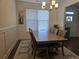 Bright dining room with a modern chandelier, wainscoting detail, and a large window for natural light at 1200 Bar Harbor Pl, Lawrenceville, GA 30044