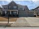 Beautiful two-story home with stone accents, a well-maintained lawn, and a three-car garage on a sunny day at 1200 Bar Harbor Pl, Lawrenceville, GA 30044