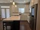 Modern kitchen with stainless steel appliances, white cabinetry, a center island, and a tile backsplash at 1200 Bar Harbor Pl, Lawrenceville, GA 30044