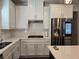 Bright kitchen featuring white cabinets, a subway tile backsplash, stainless steel appliances, and quartz countertops at 1200 Bar Harbor Pl, Lawrenceville, GA 30044