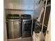 This laundry room features a modern washer and dryer with white cabinets above at 1200 Bar Harbor Pl, Lawrenceville, GA 30044