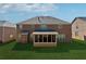 Backyard featuring a screened porch and full brick exterior at 1263 Polk Xing, Mcdonough, GA 30252