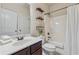 Well-maintained bathroom featuring a single sink vanity and a shower-tub combo with tiled walls and a shower curtain at 1263 Polk Xing, Mcdonough, GA 30252