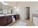 Bathroom features double vanity sinks, dark wood cabinets, and updated fixtures at 1263 Polk Xing, Mcdonough, GA 30252