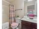 Bright bathroom features a shower and vanity with dark brown cabinets and neutral tones at 1263 Polk Xing, Mcdonough, GA 30252