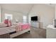 Bright bedroom featuring a large dresser with mounted TV at 1263 Polk Xing, Mcdonough, GA 30252