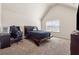 Carpeted bedroom has a vaulted ceiling, a computer desk, and a bed with dark bedding at 1263 Polk Xing, Mcdonough, GA 30252