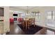 Dining area with wooden table and chairs, large windows, and view to living room at 1263 Polk Xing, Mcdonough, GA 30252