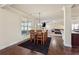 Bright dining area with wooden table, view of living room and a view to kitchen at 1263 Polk Xing, Mcdonough, GA 30252