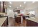 Open kitchen with granite countertops, stainless steel appliances, and island at 1263 Polk Xing, Mcdonough, GA 30252