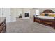 Spacious main bedroom offers a cozy fireplace and a stately, traditional bed frame at 1263 Polk Xing, Mcdonough, GA 30252