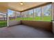Screened porch with neutral colors, large windows and view of backyard at 1263 Polk Xing, Mcdonough, GA 30252