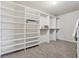 Spacious walk-in closet with custom shelving and carpet floors at 1263 Polk Xing, Mcdonough, GA 30252