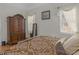 Cozy bedroom features soft natural light, warm paint, and a charming armoire at 355 Parker Rd, Covington, GA 30014