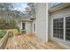 Exterior of home with a wooden deck, siding, and view of the treed backyard at 105 Spring Forest Way, Sharpsburg, GA 30277