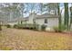 Exterior rear view of house with wood deck and wooded backyard at 105 Spring Forest Way, Sharpsburg, GA 30277