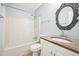 Bathroom featuring a shower-tub combo, granite vanity top, and stylish mirror, providing a fresh feel at 105 Spring Forest Way, Sharpsburg, GA 30277