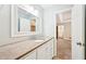 Bathroom vanity with stone countertop, white cabinets, and modern fixtures at 105 Spring Forest Way, Sharpsburg, GA 30277