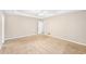 Spacious bedroom with neutral walls, beige carpet, and a ceiling fan at 105 Spring Forest Way, Sharpsburg, GA 30277