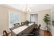 A beautifully staged dining room with a classic table setting and natural light from the window at 105 Spring Forest Way, Sharpsburg, GA 30277